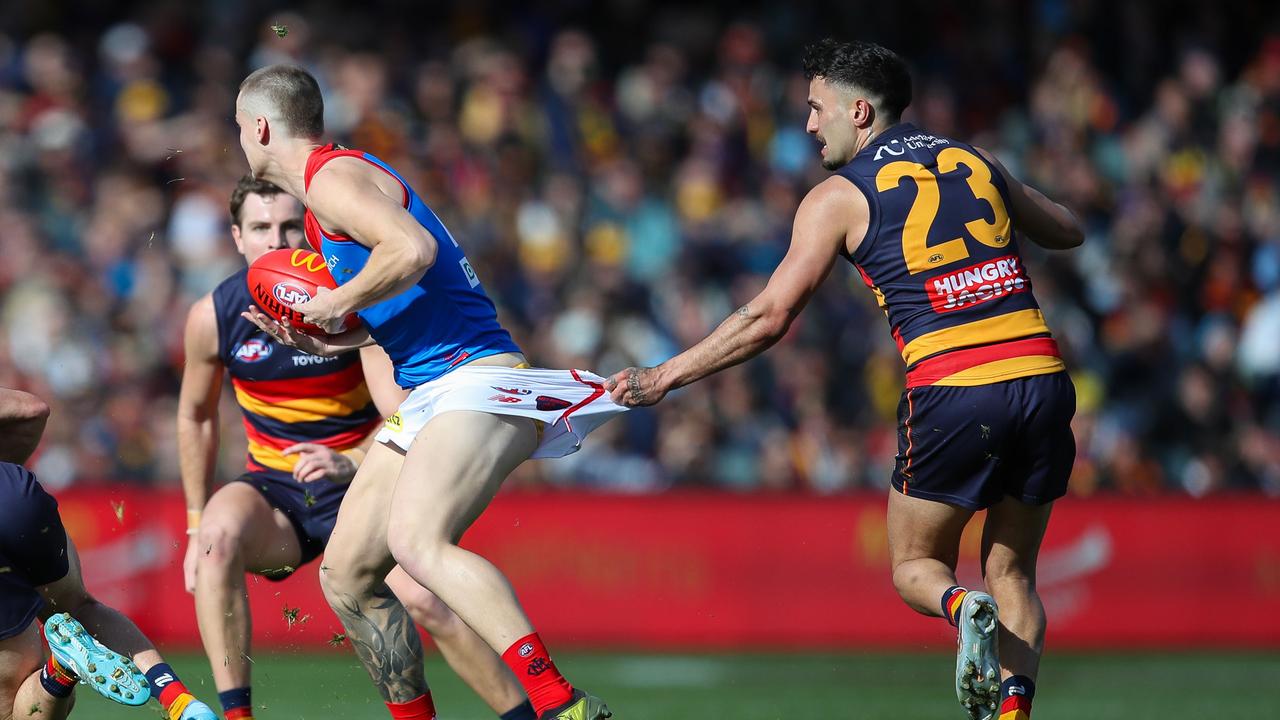 Trent Rivers of the Demons is tackled by Izak Rankine