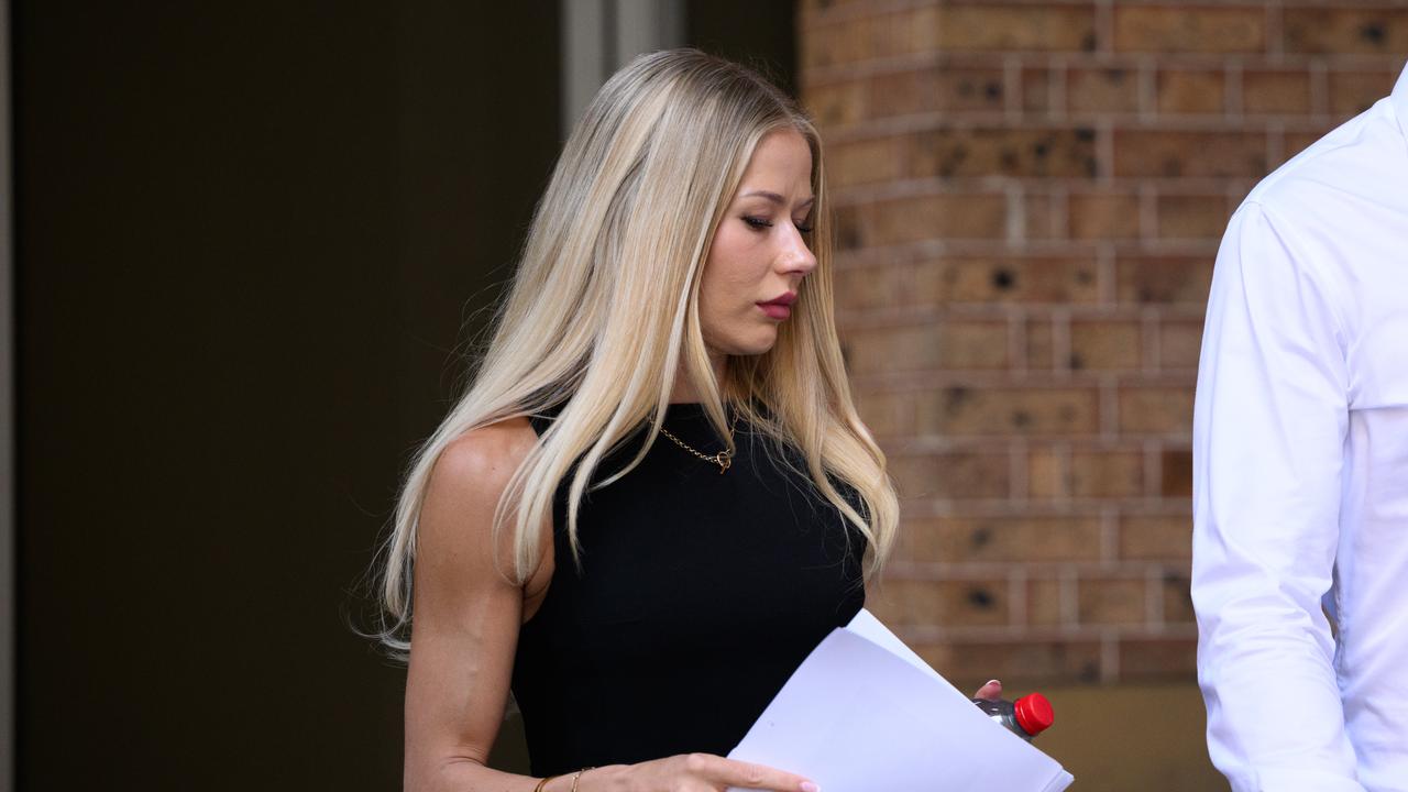 woman walks out of court