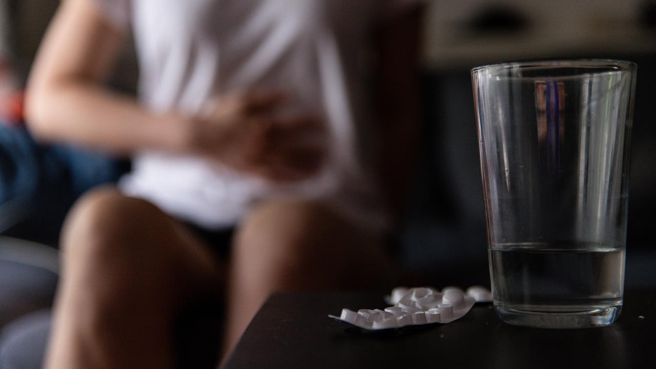A woman holds her stomoach (file image)