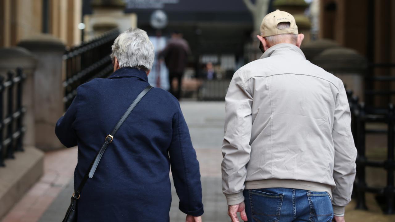 Elderly people walk down a street (file image)