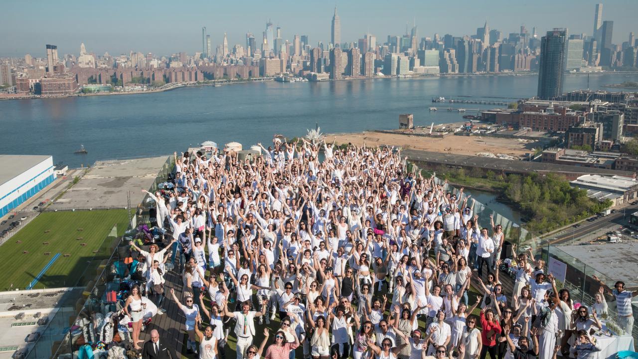 people dancing with the New York City skyline in the background