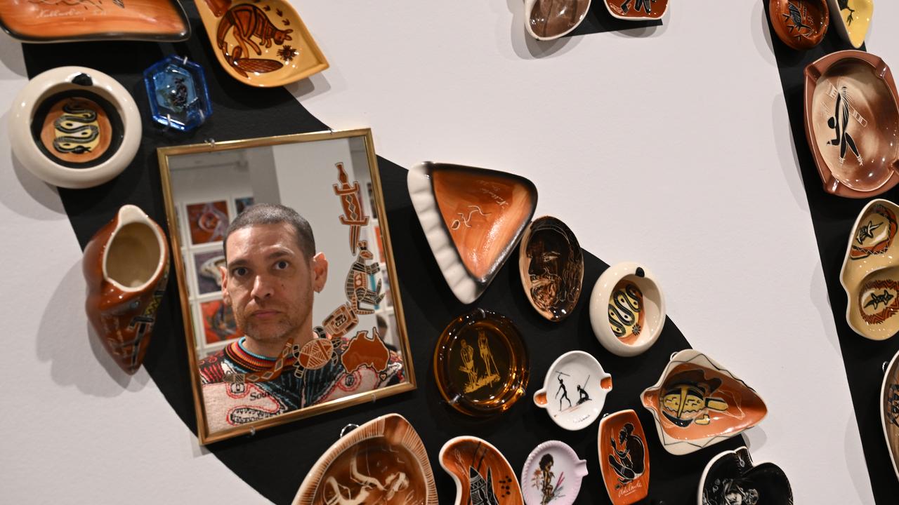 Artist Tony Albert is seen reflected in a mirror in his piece Ashamed