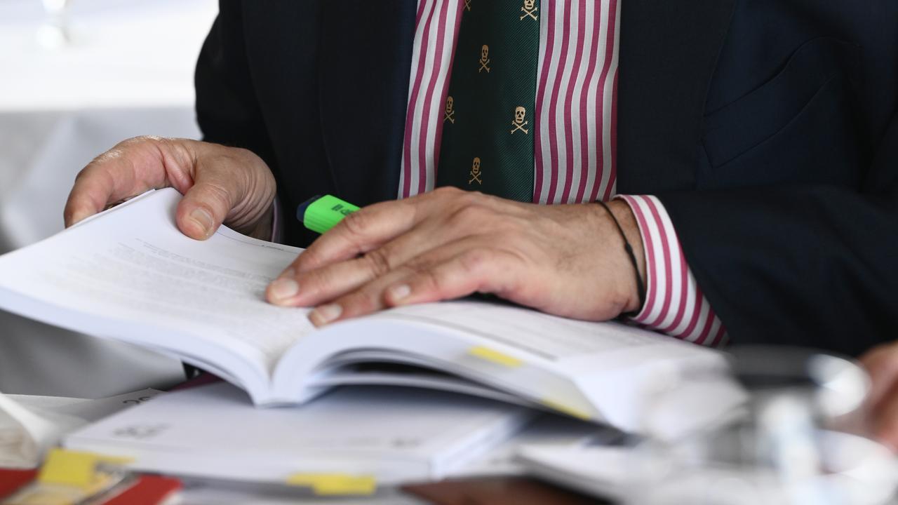 Journalists read copies of the Victoria State Budget