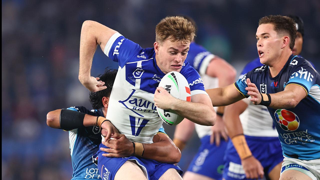 The Bulldogs' Lachie Galvin looks to break free against the Titans.
