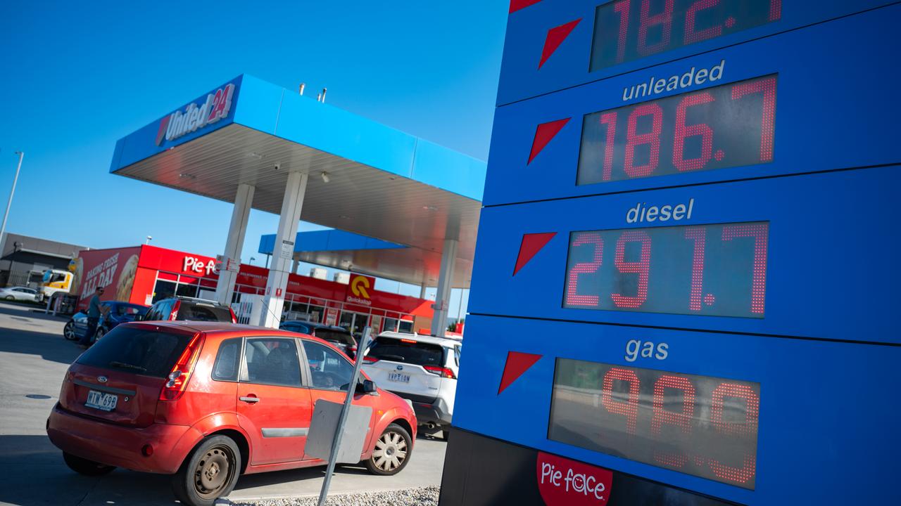 Motorists fill their cars with petrol at a service station