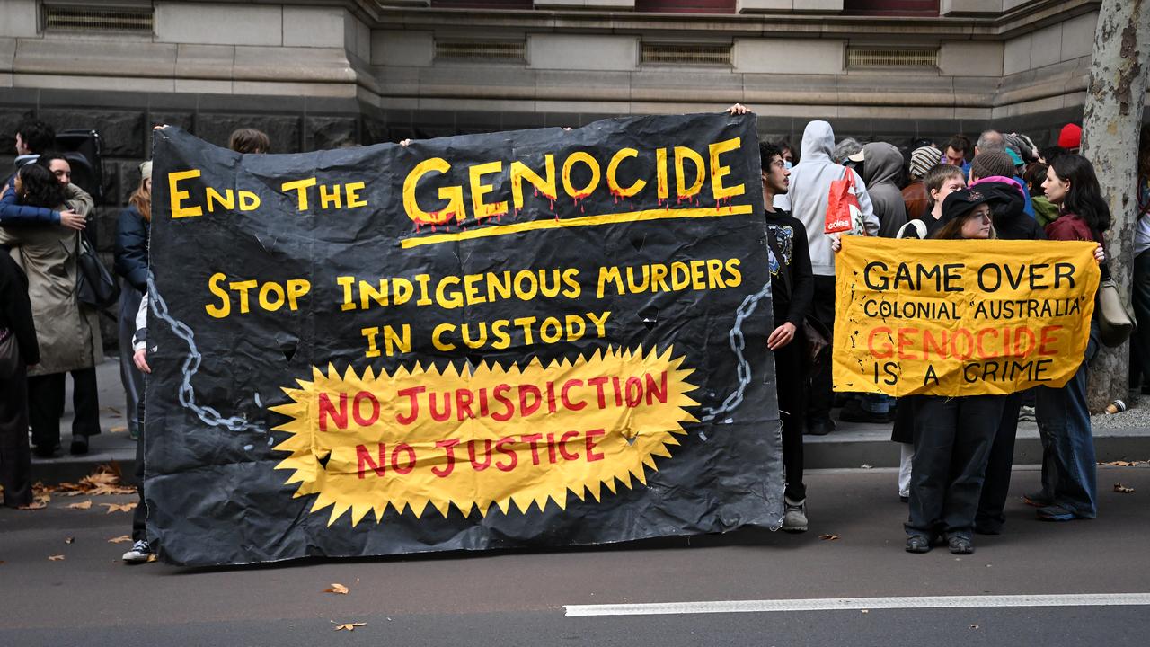 Crowds gather with placards outside of the Supreme Court of Appeal