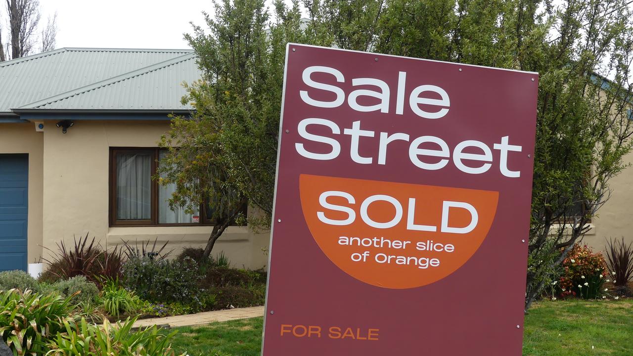 A sold sign is displayed outside a house.