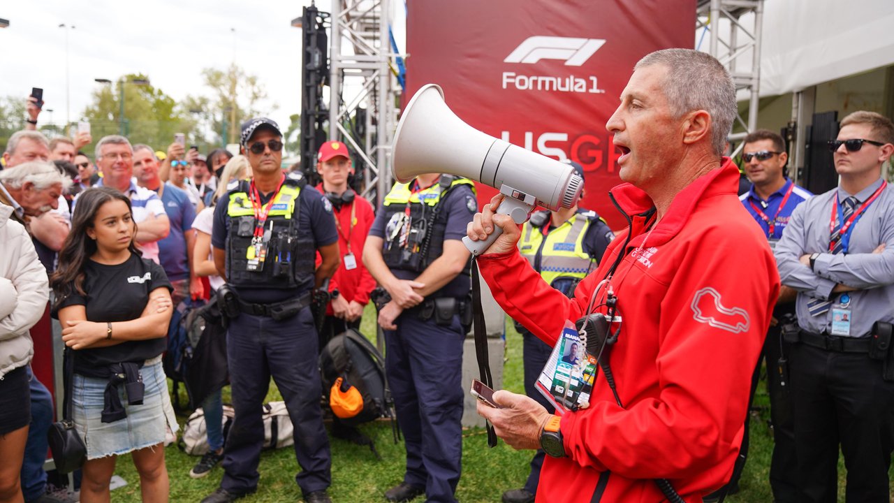 AusGP official with megaphone near fans