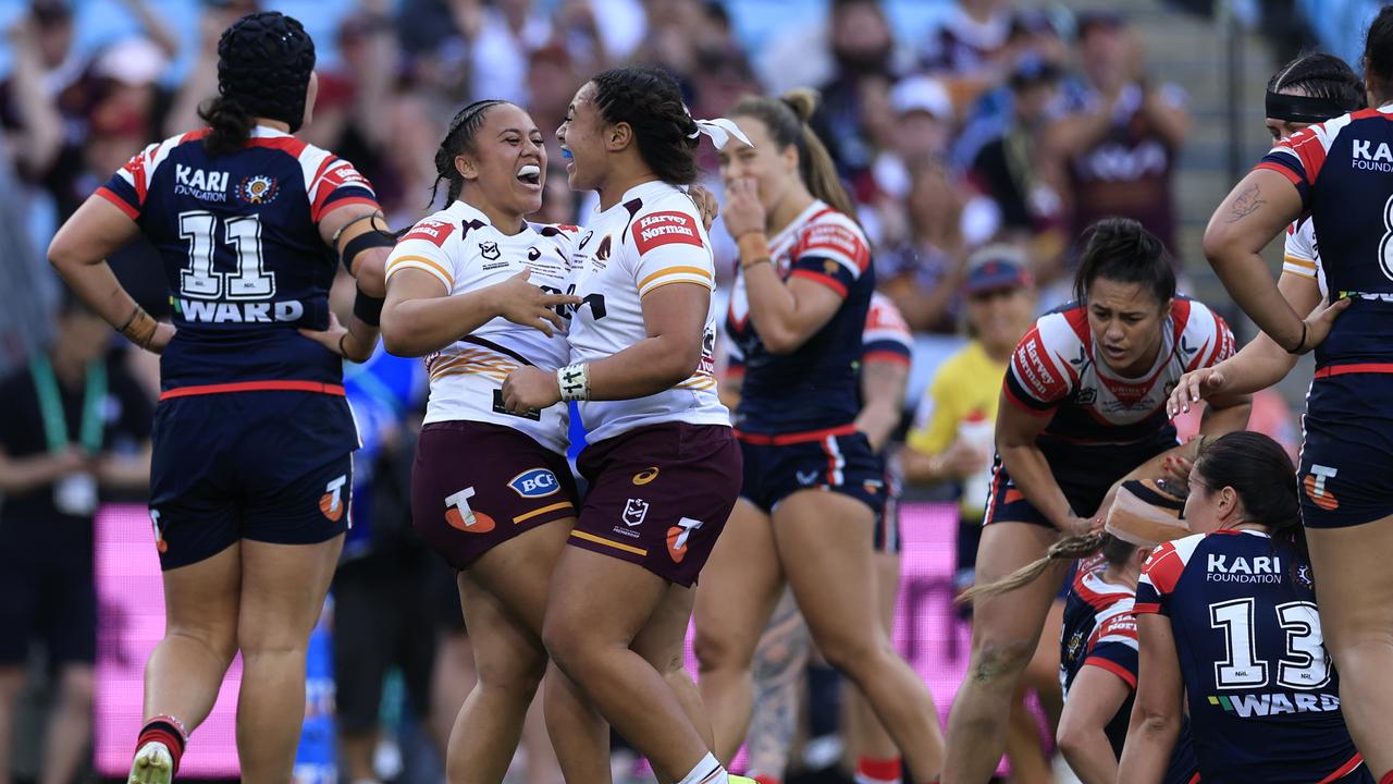 Brisbane players celebrate scoring a try