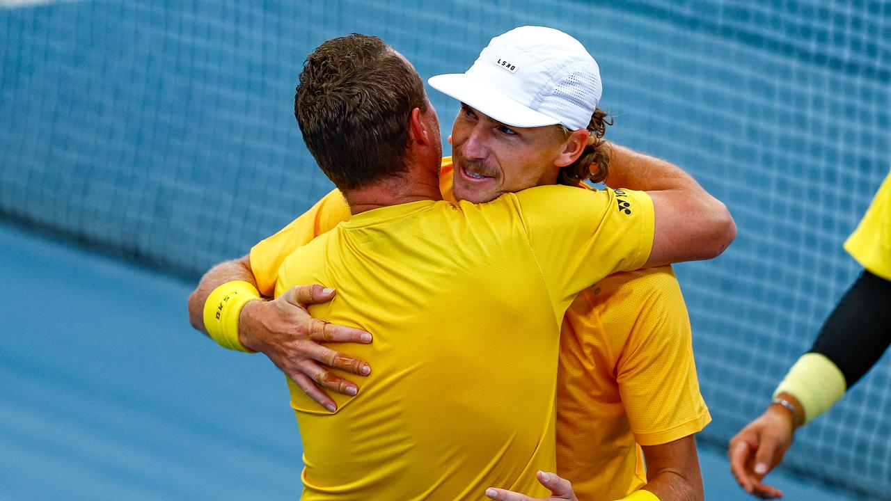 Australia's captain Lleyton Hewitt embraces Max Purcell