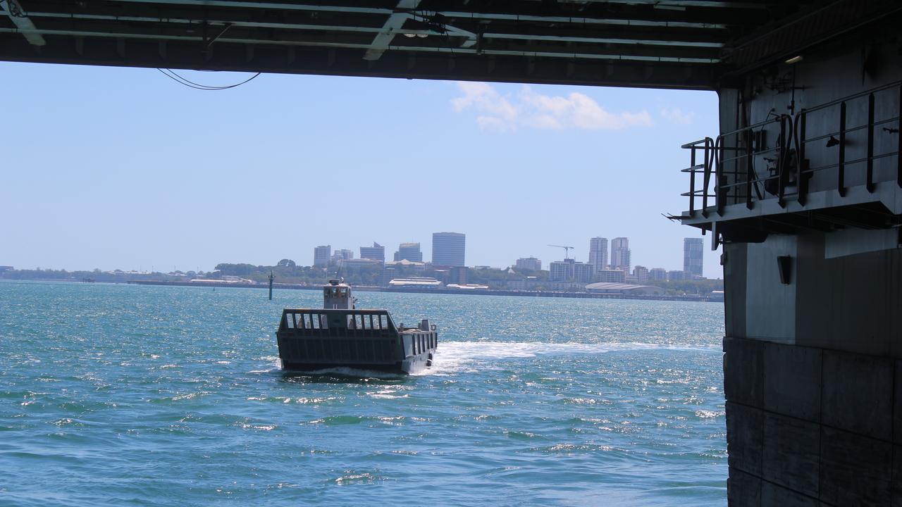 A landing craft approaches the stern of HMAS Canberra off Darwin.