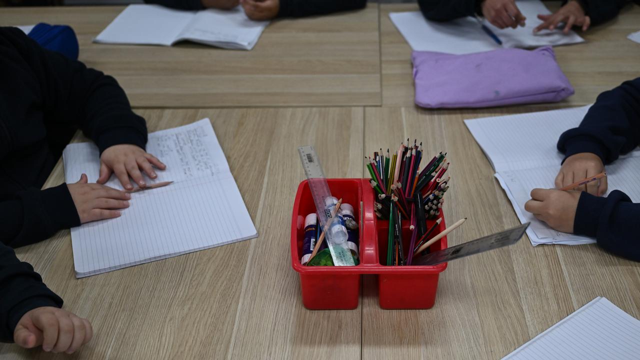 Students writing in a classroom