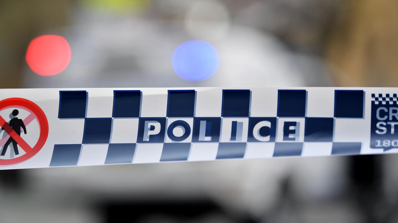Police tape restricts access to a street