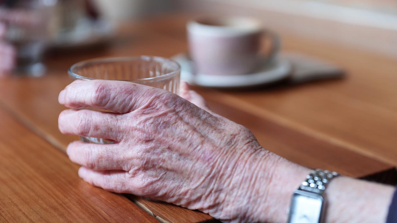 An elderly person holds a cup (file image)