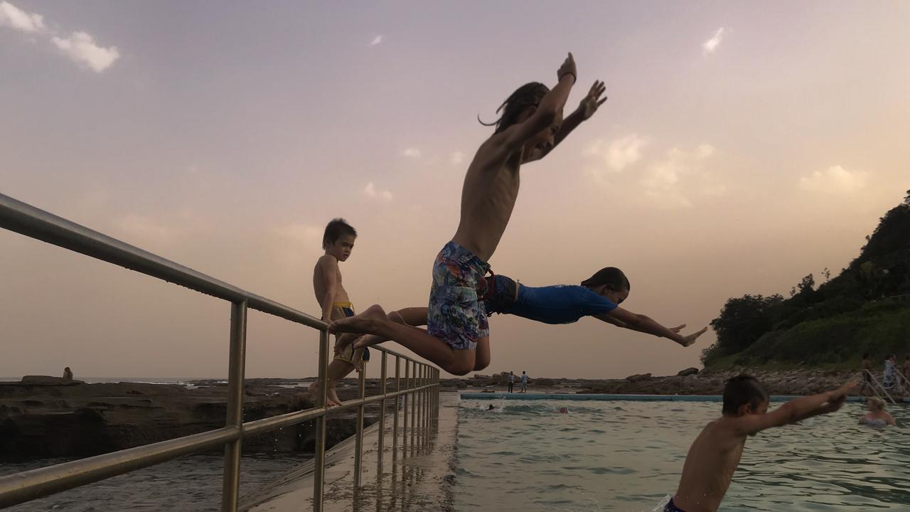 Children swim in a rockpool