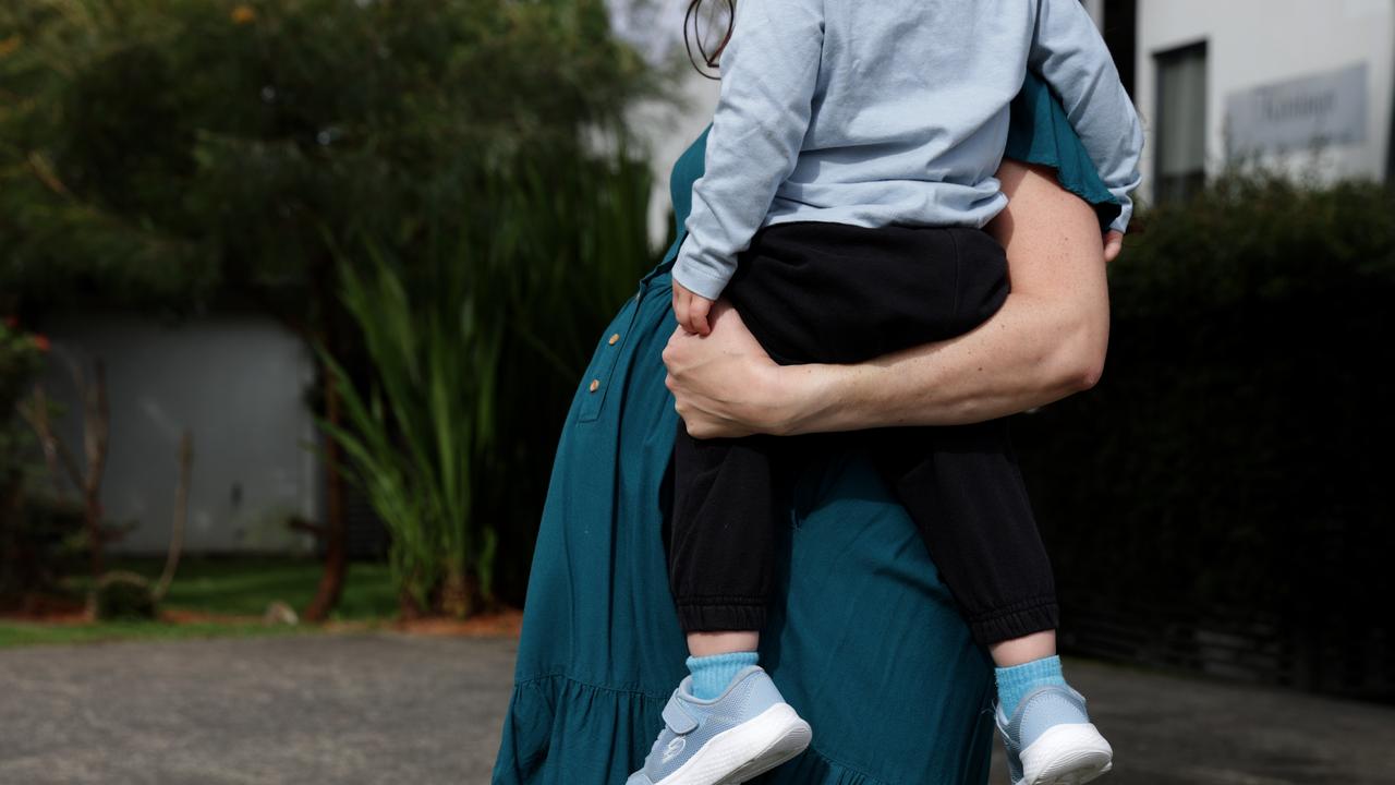 A pregnant person with a child