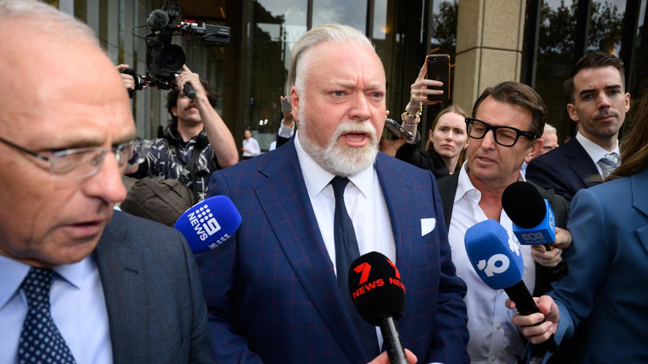 Kyle Sandilands surrounded by media