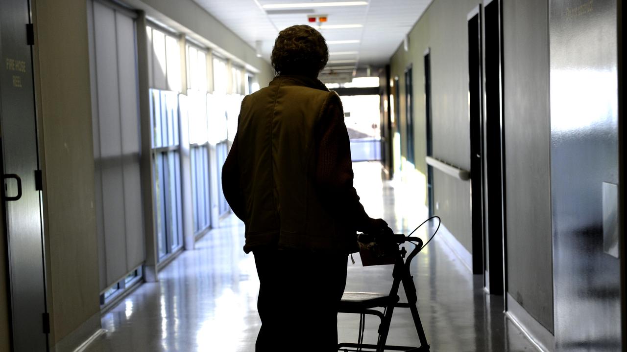 A woman uses a walker to assist her mobility