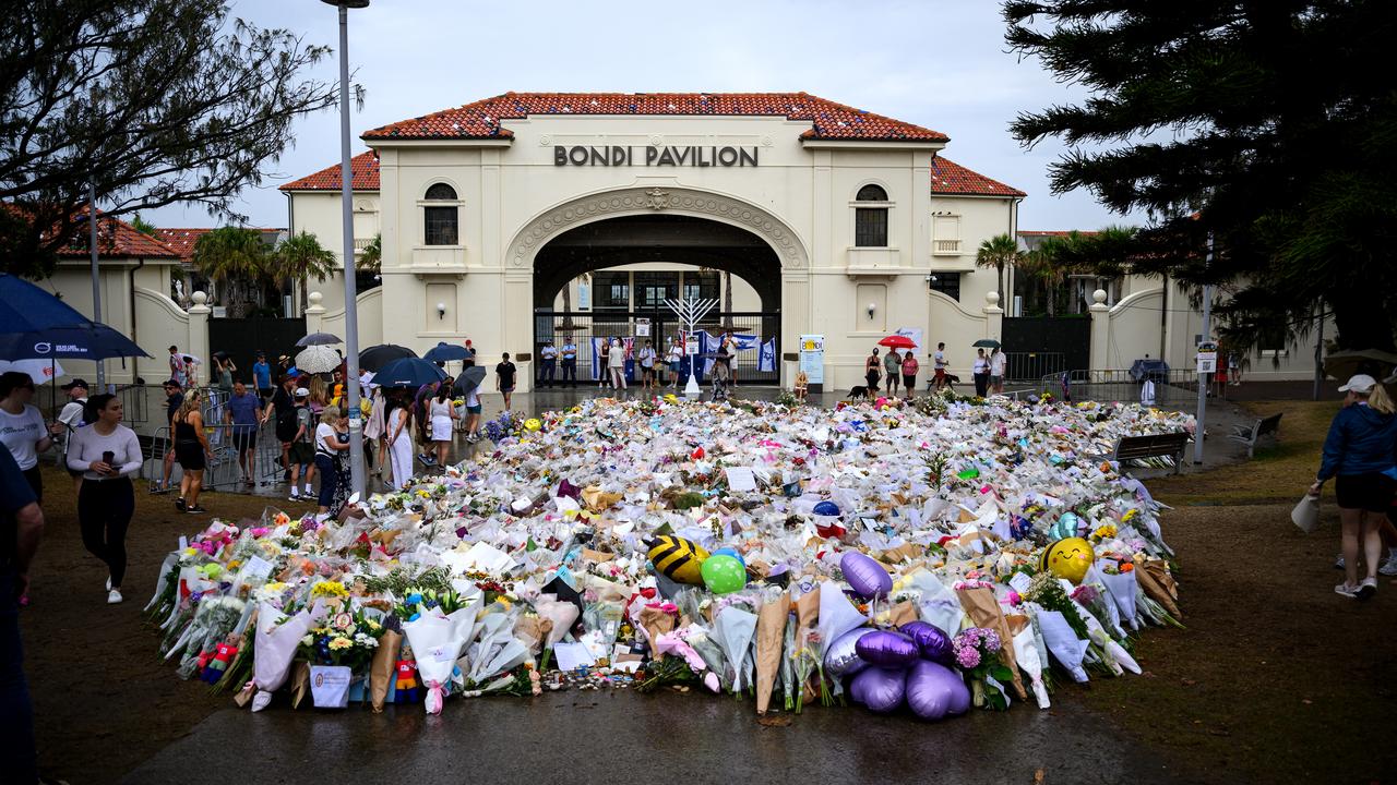 Mourners place flowers at a memorial at Bondi Beach