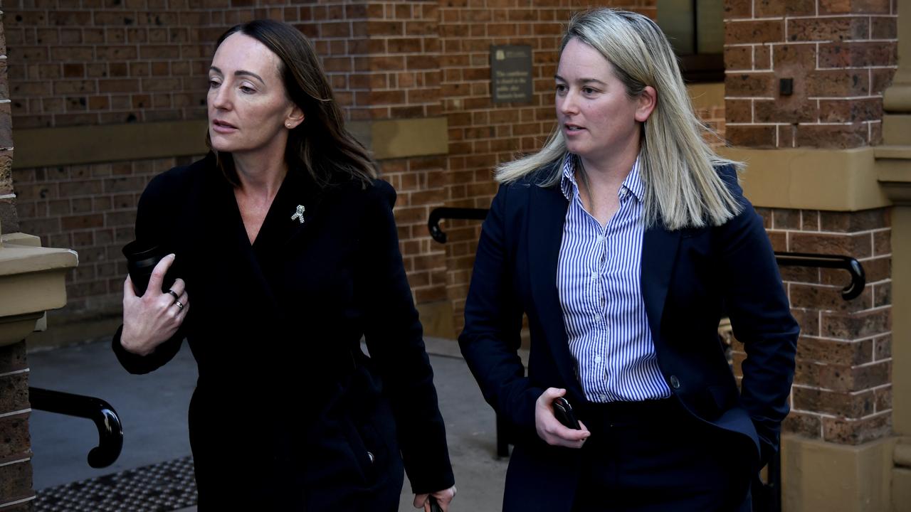 women walking out of court