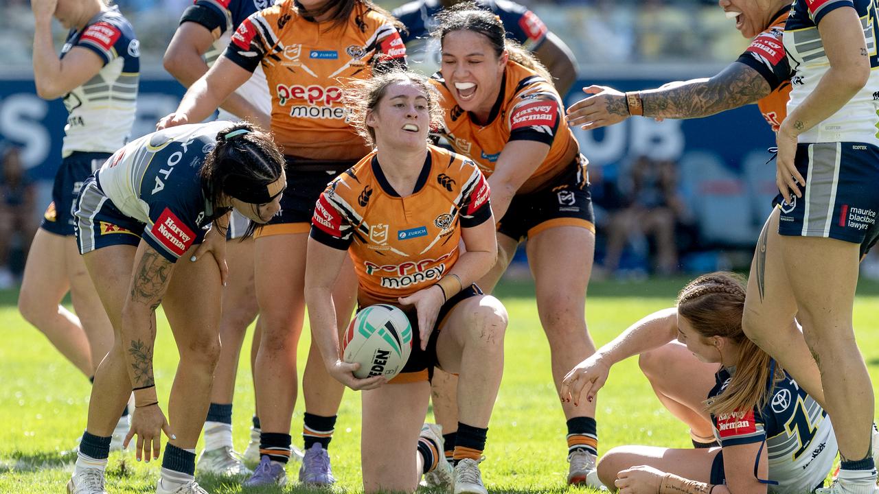 Faythe Manera of the Tigers celebrates with teammates after  a try