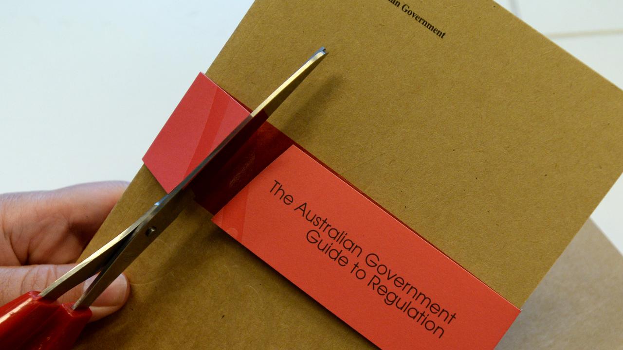 Scissors cutting red tape (file image)