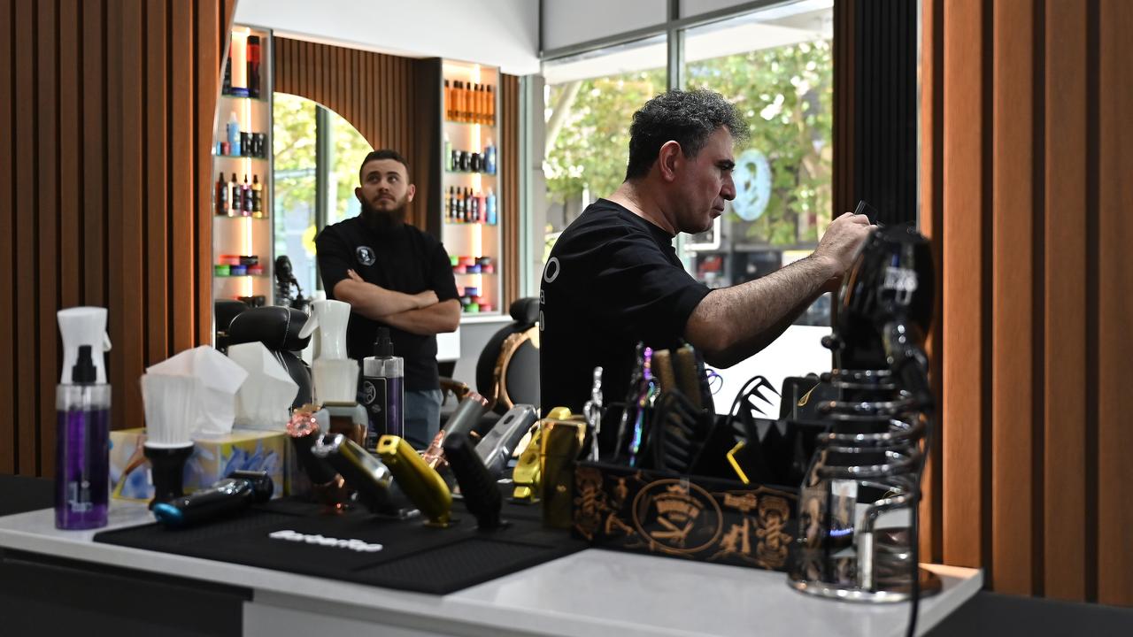 A man receives a haircut at Boston Cut Barber