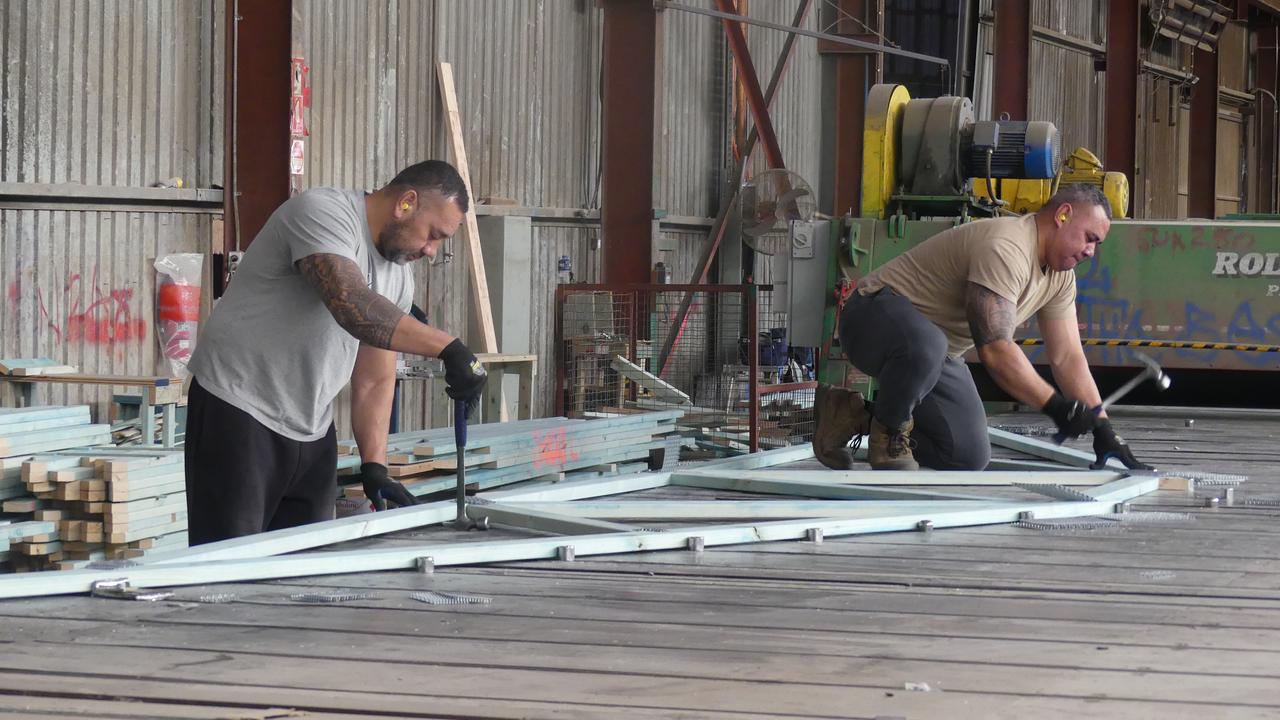 Workers construct house frames and trusses at the Westruss