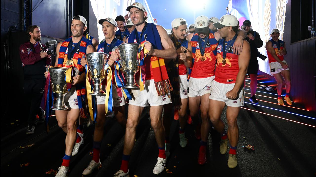 (L-R) Josh Dunkley of the Lions,