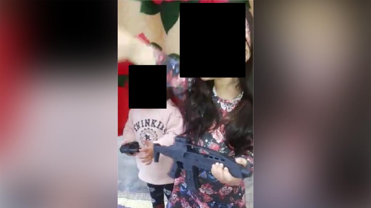 two children holding what appears to be weapons