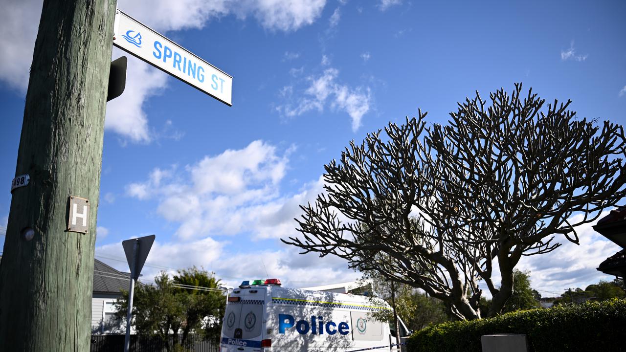 street sign in foreground, police van in background