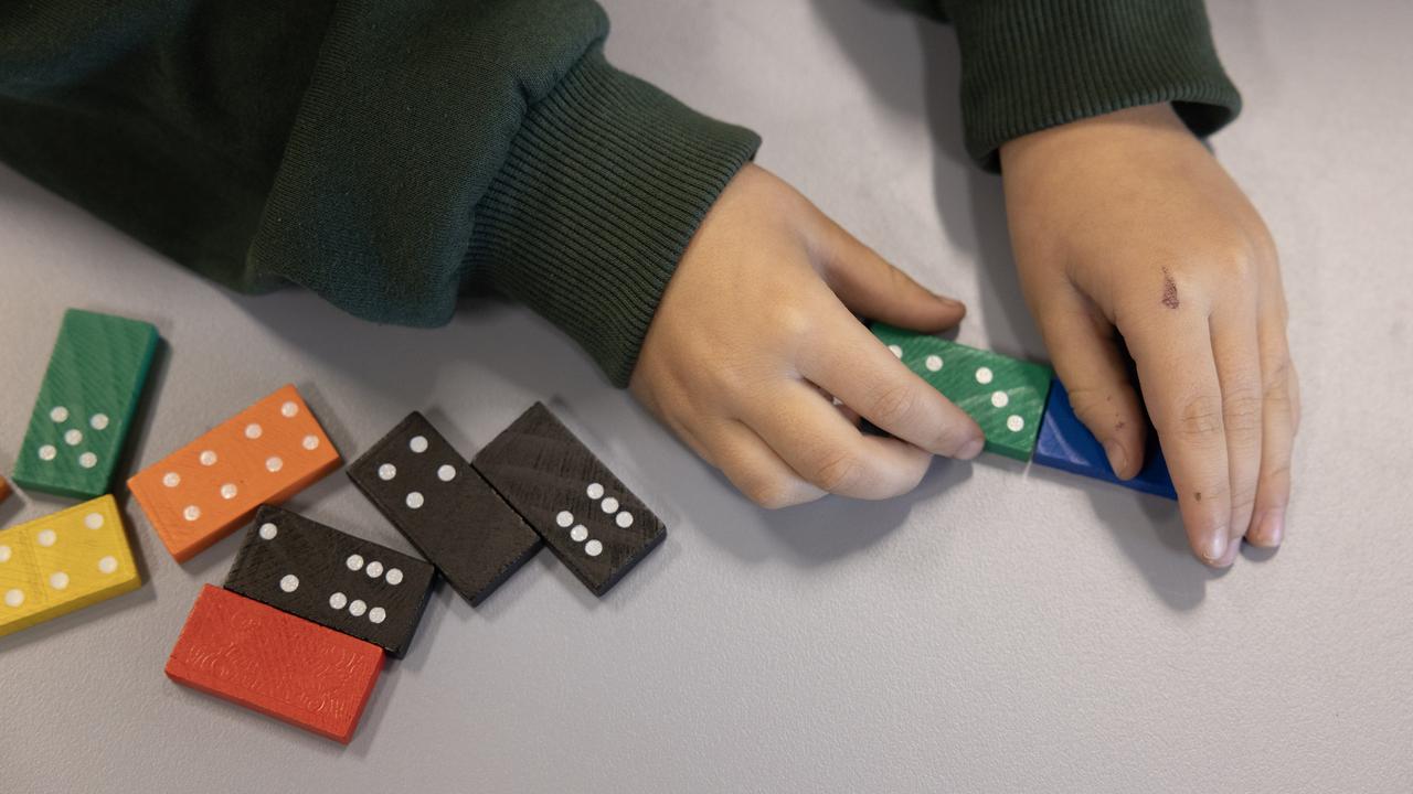 School children playing with dominoes