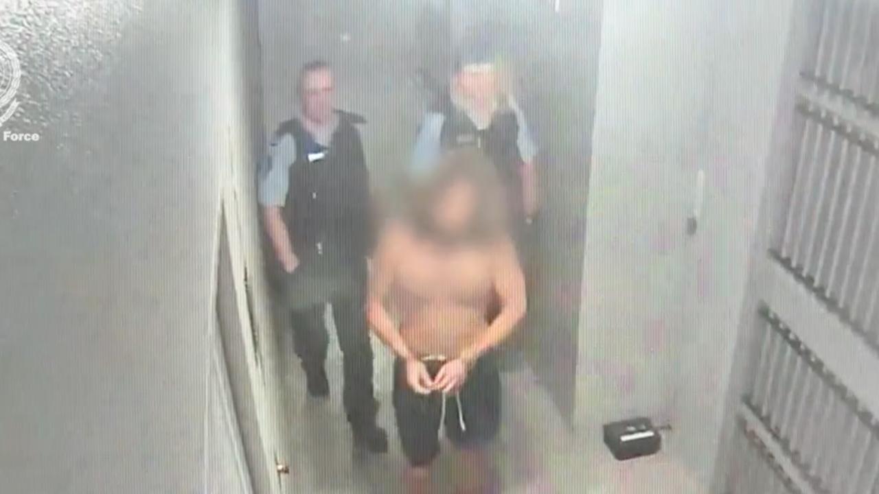 Blurred image of man in handcuffs in police watchhouse