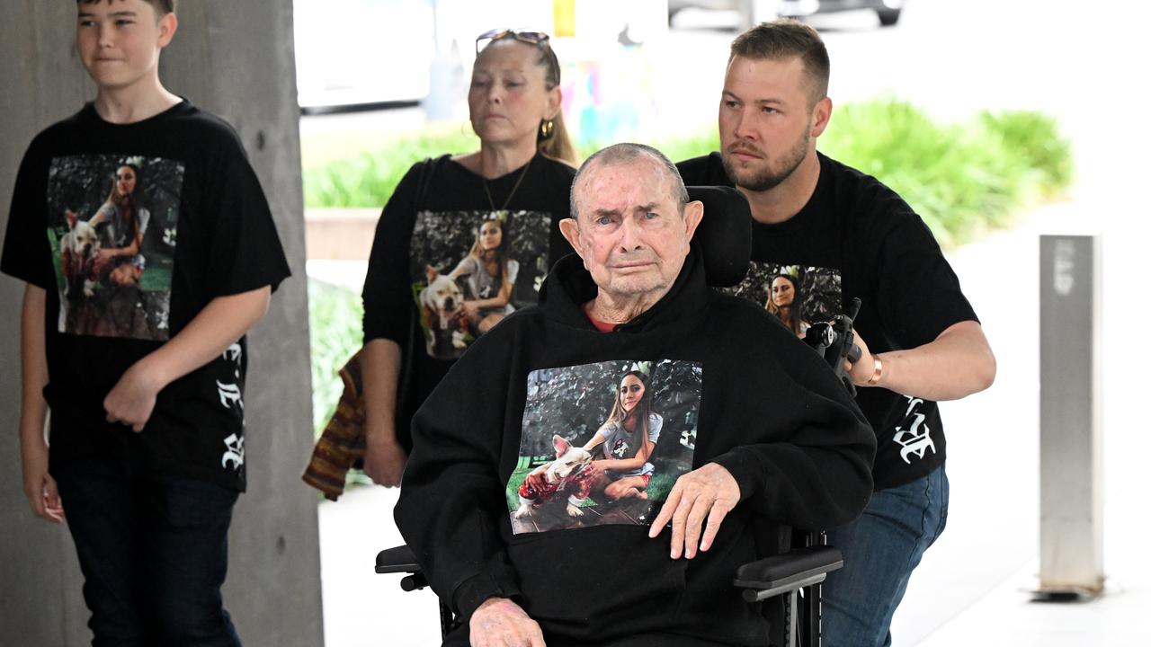 Four people approach a courthouse wearing shirt with vicitm's image