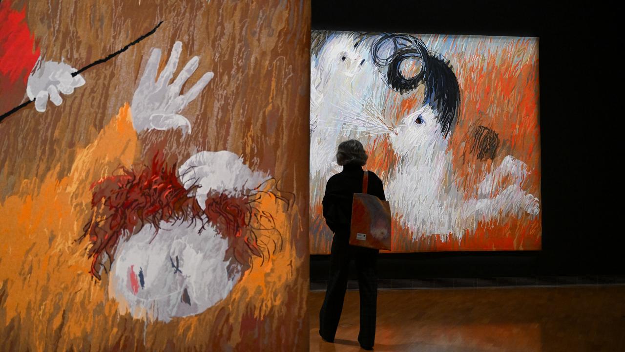 A guest takes a look at tapestries