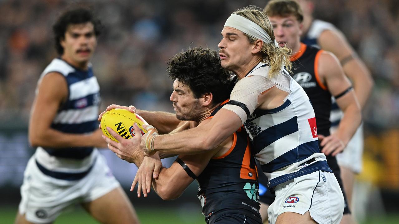 Bailey Smith of Geelong tackles George Hewett of Carlton