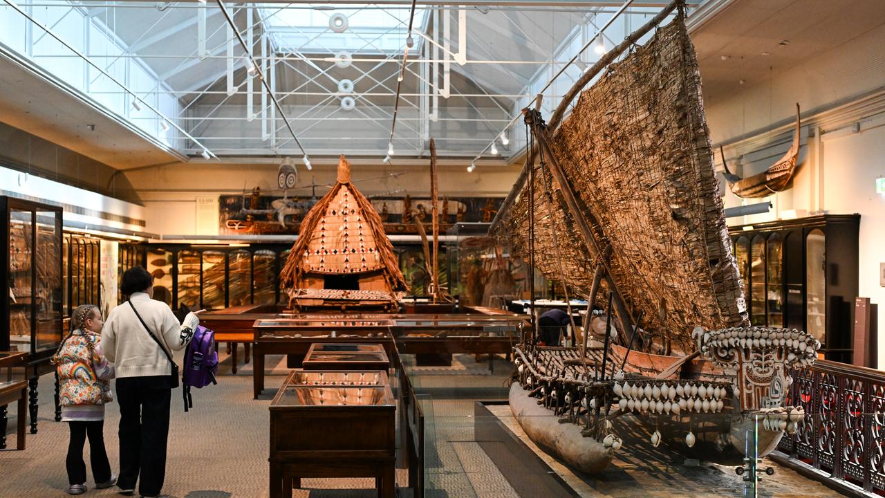 People look at museum displays.
