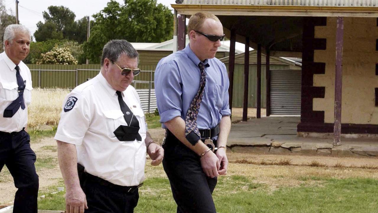 Robert Joe Wagner is escorted handcuffed