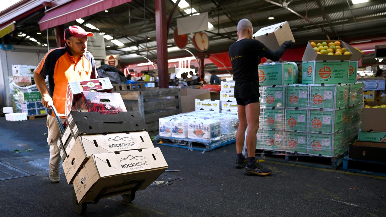 Workers stock fresh produce (file image)